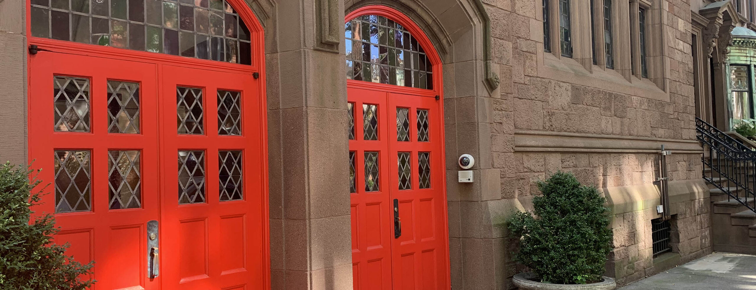 Carriage house exterior with red doors