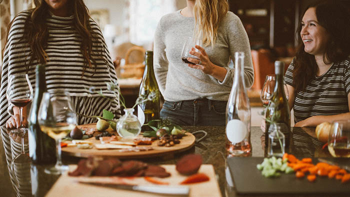 Women Having Wine and Cheese at Counter