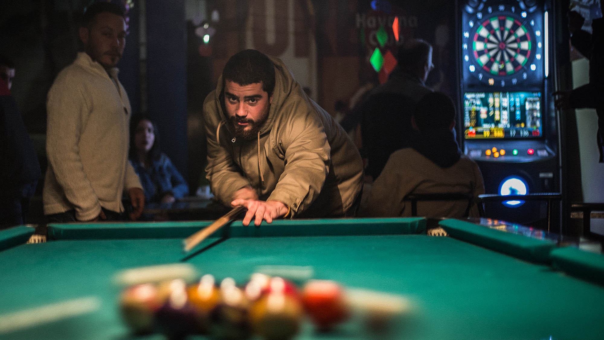 Man Playing Pool in Bar