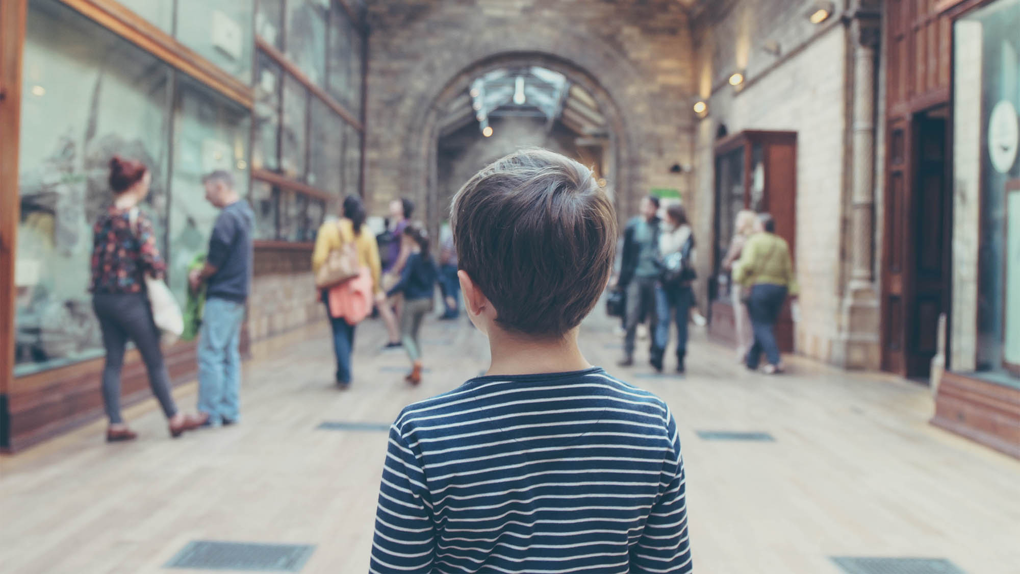 Boy Walking Through Museum from the Back