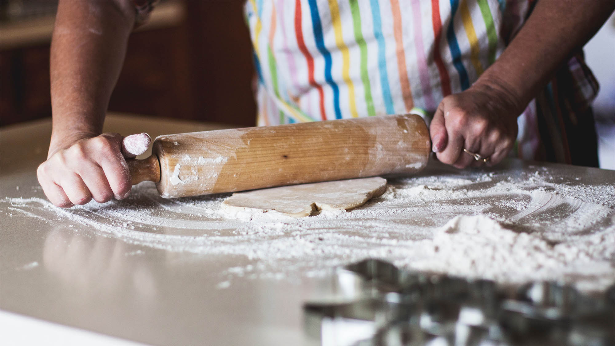 Hands Rolling Cookie Dough on Counter