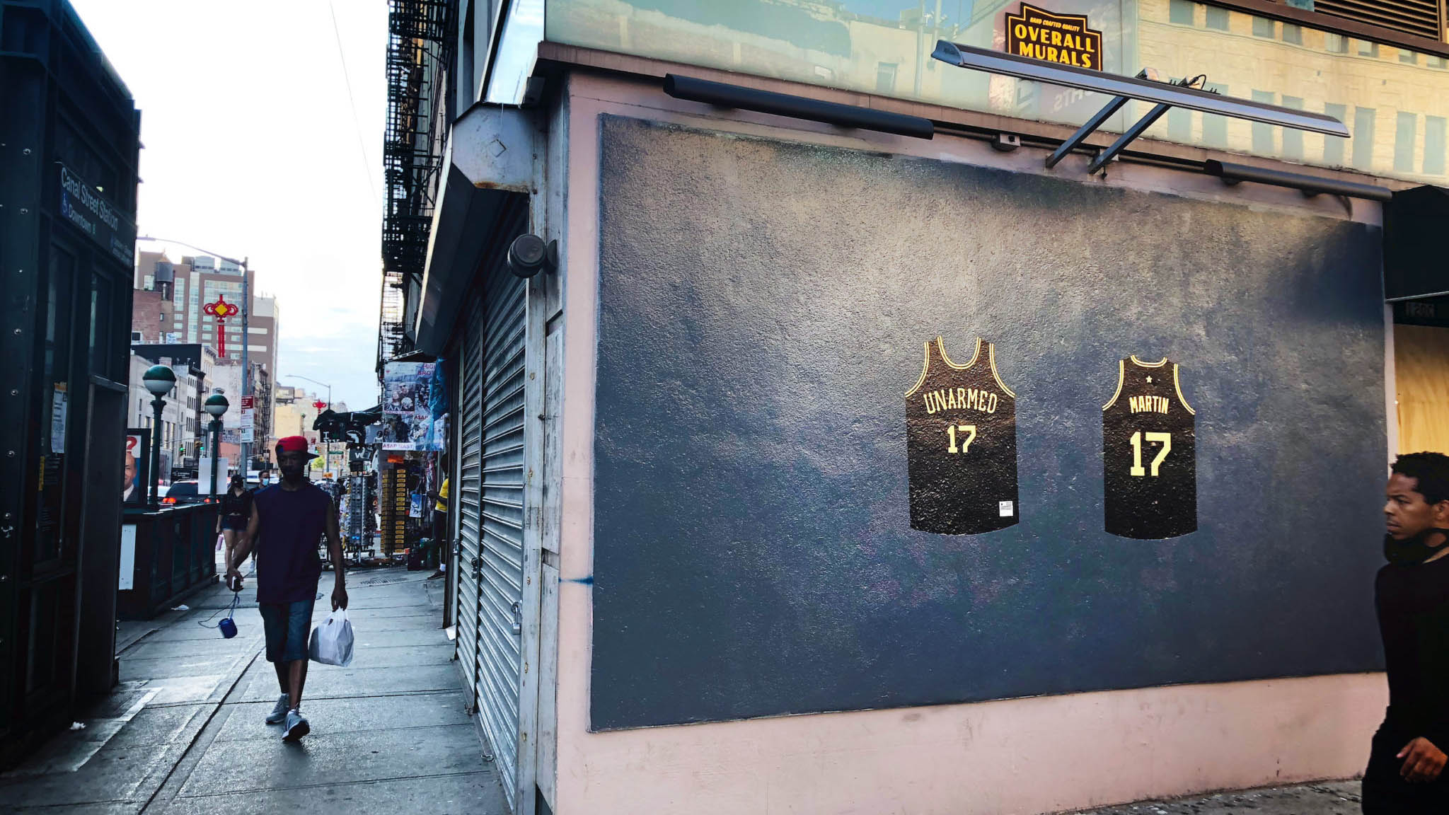 Two Black Jerseys Hanging on Wall Art Exhibit