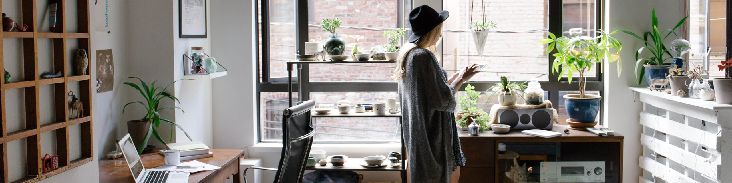 Woman with Hat Standing at Her Apartment Window