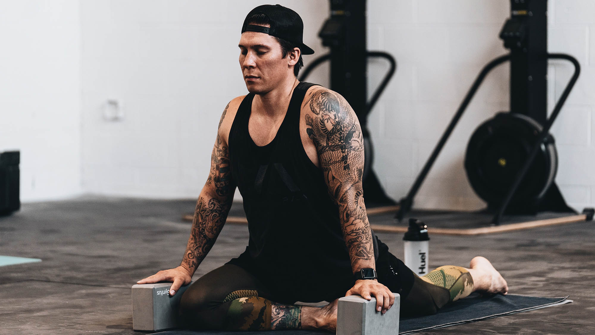 Tattooed man doing yoga