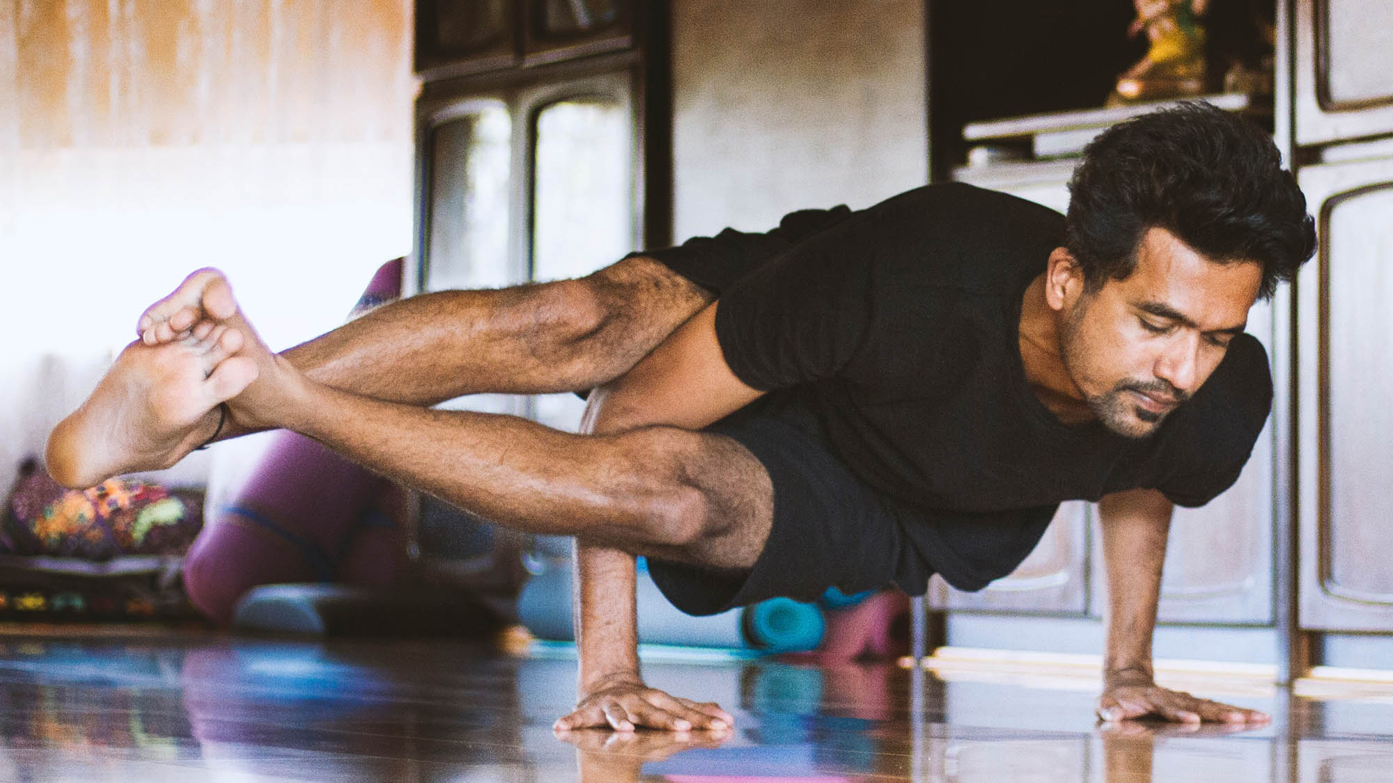 Man doing yoga at home