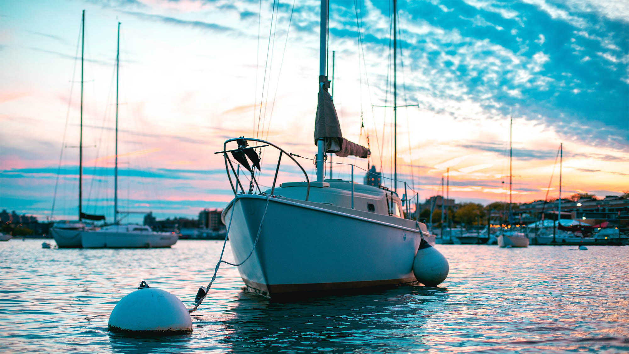 Docket boat beneath pink white and blue sunset sky