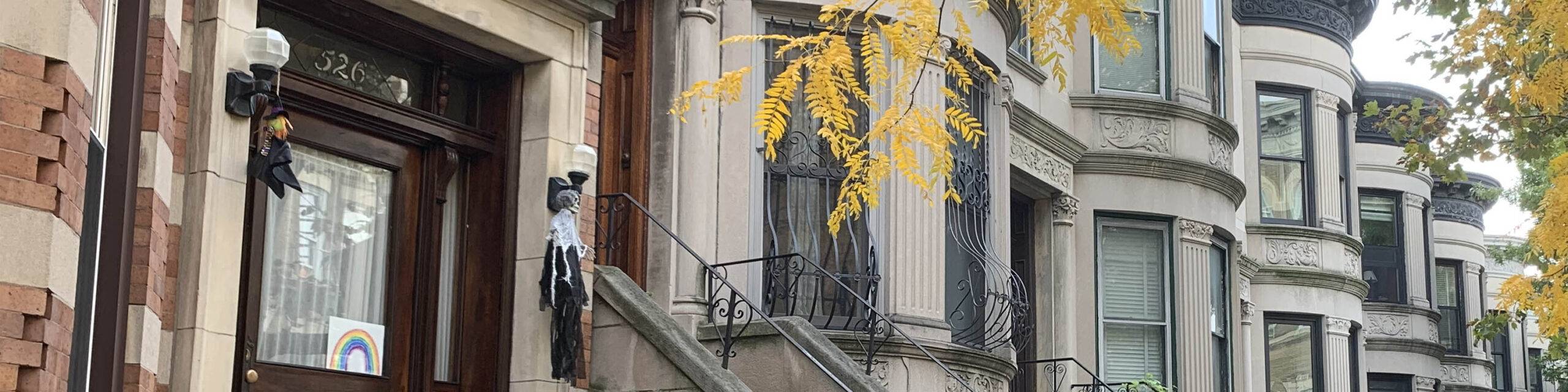 Row of Brooklyn brownstone homes decorated for fall