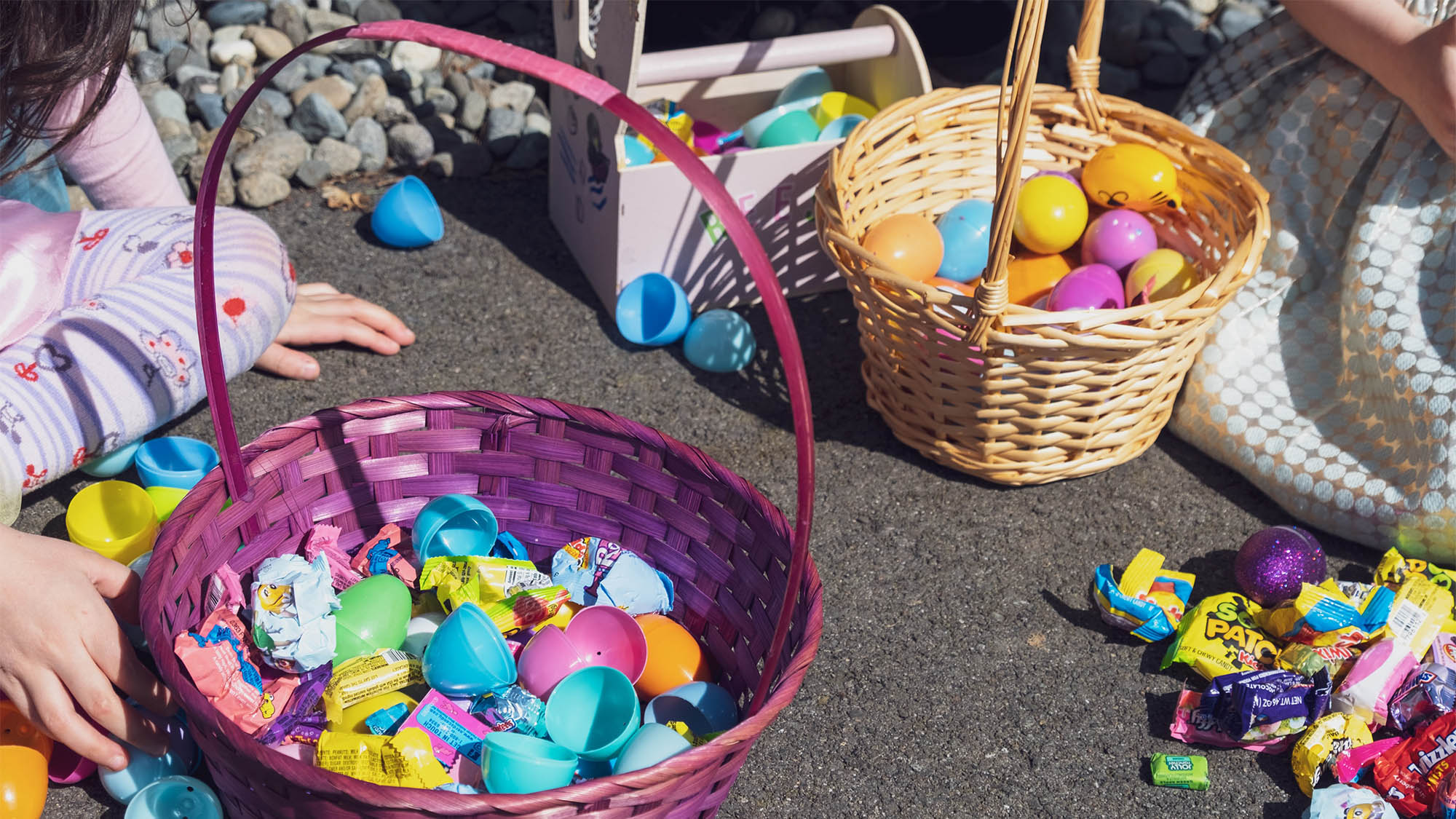 Two Easter baskets filled with assorted plastic eggs and candies