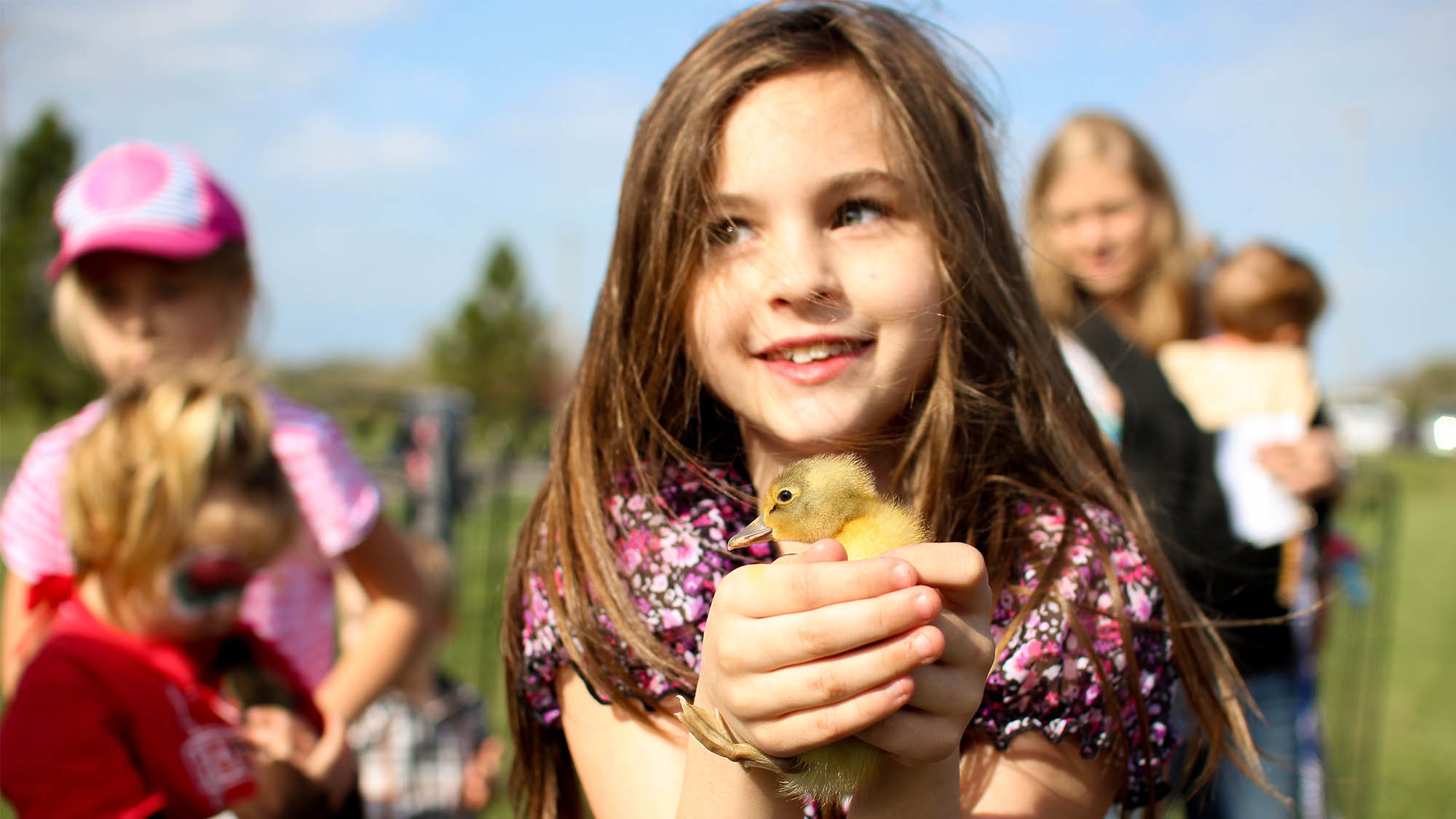 White girl holding baby chick