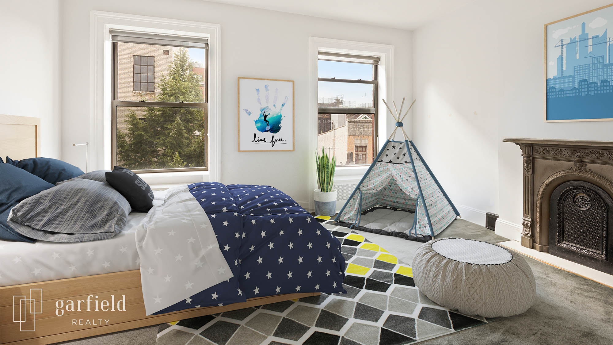 Virtually staged kids bedroom with blue and white polka dot comforter blue pillows on geometric throw rug next to bean bag chair and teepee tent in front of fireplace with blue artwork hanging above and to the left a handprint painting flanked by two windows