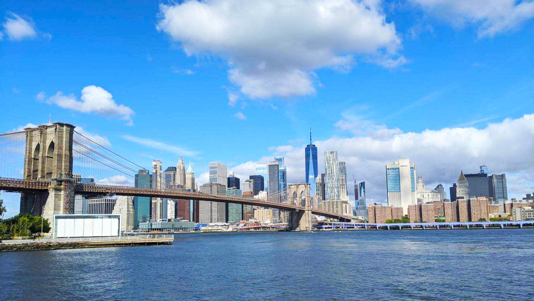 Brooklyn Bridge with Manhattan in background and East River in foreground