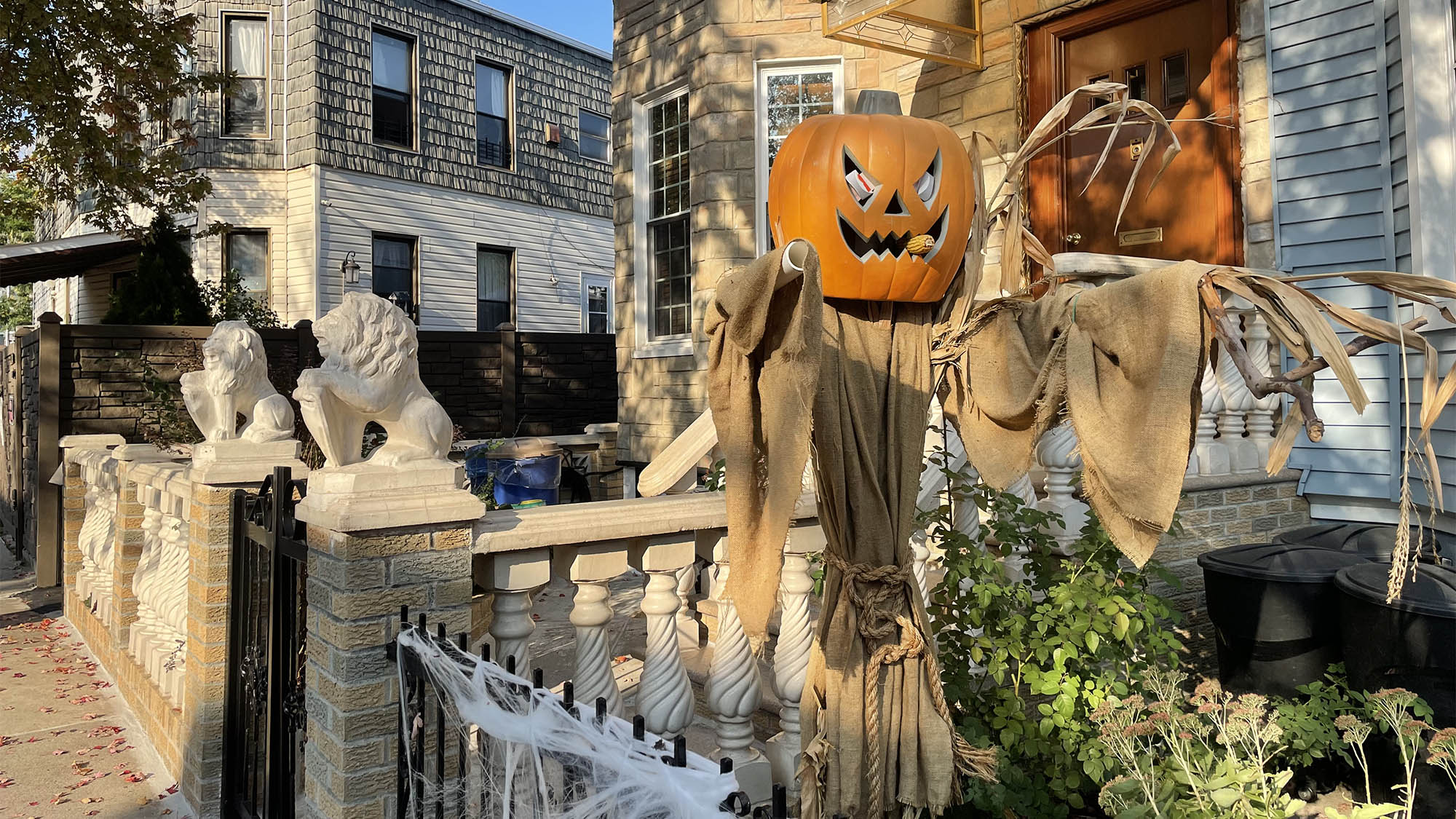 Pumpkin scarecrow decoration in Brooklyn yard