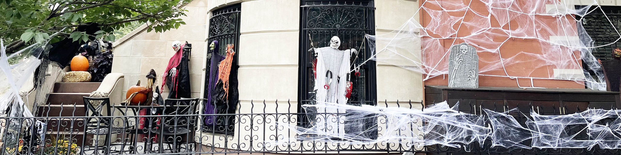 Halloween decorations hanging in windows of Brooklyn brownstone