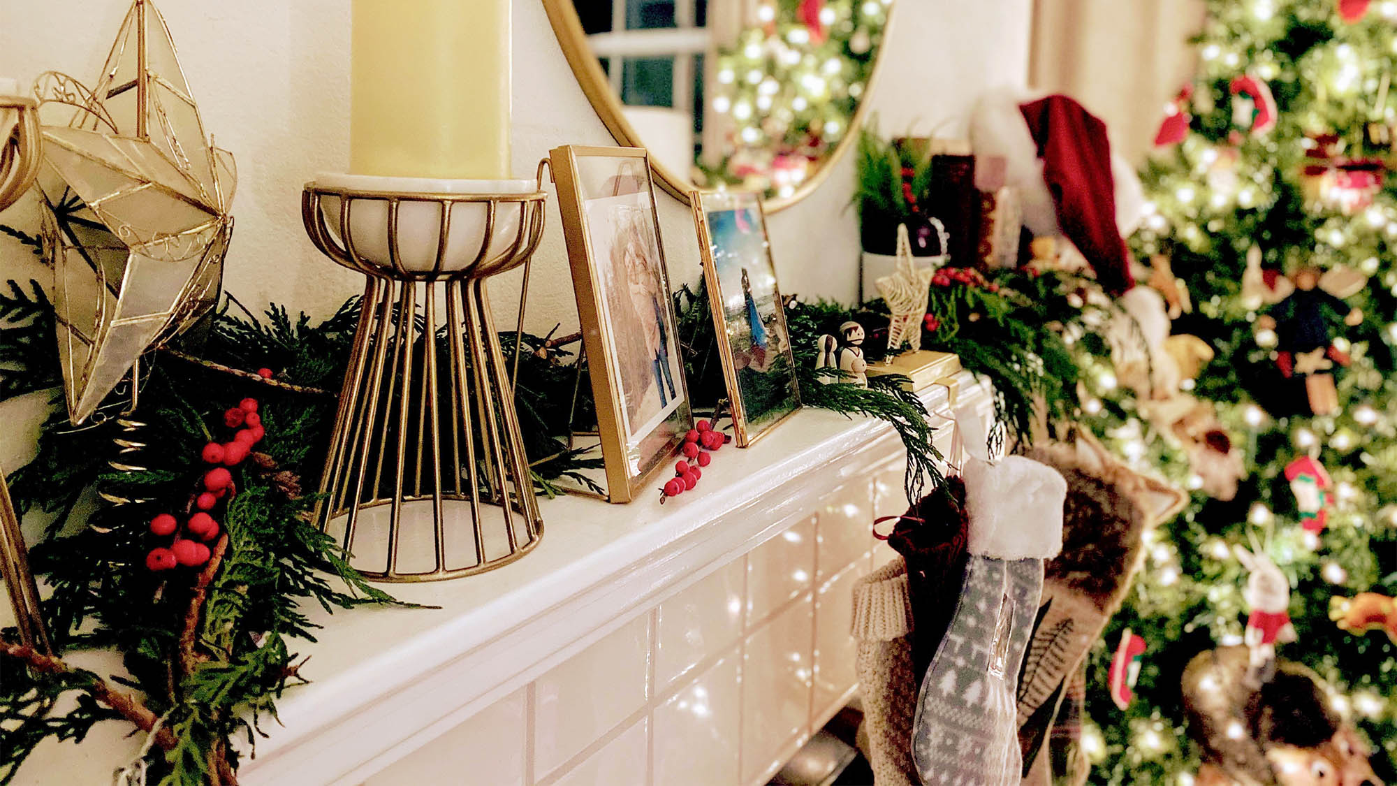 Christmas mantel with candles, frame, garland and stocking