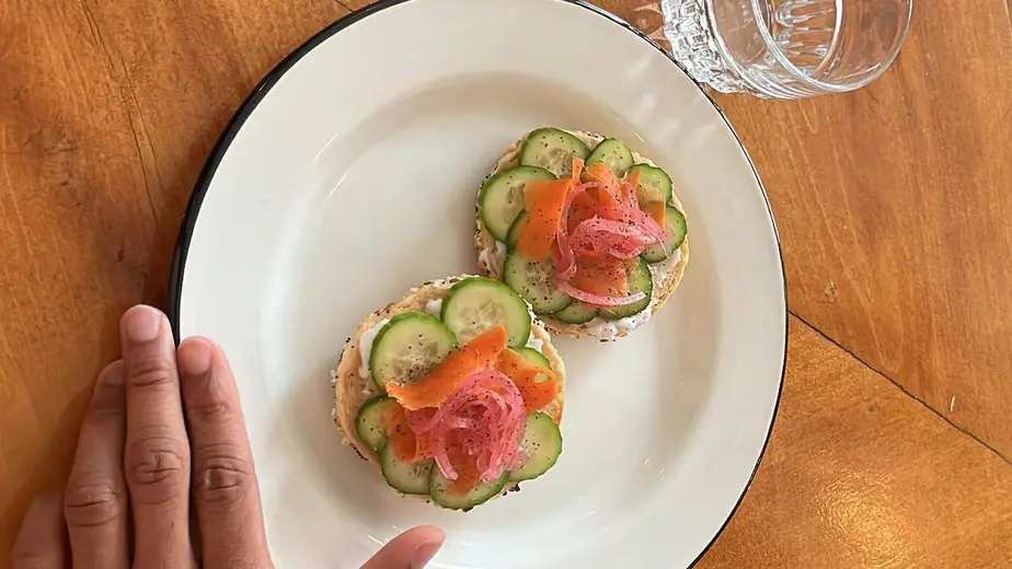 Everything bagel with lox, carrot, onion and cucumber