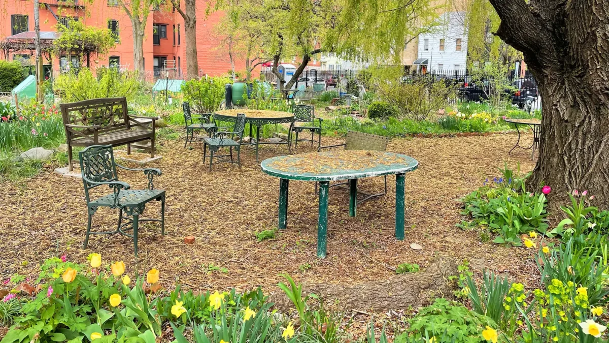 Metal tables and chairs in community garden