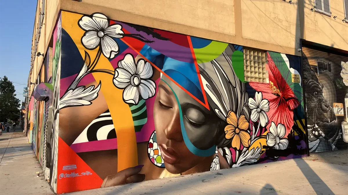 Vibrant mural of dark skinned female face with flowers surrounding it