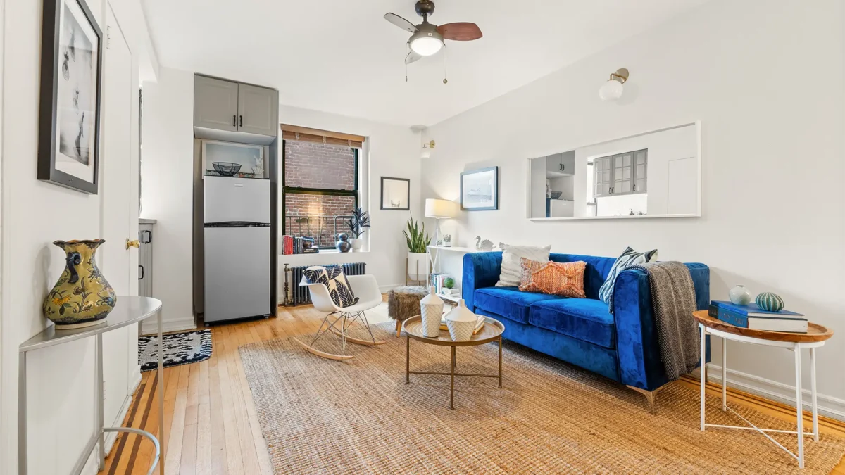 Apartment studio with couch table and refrigerator