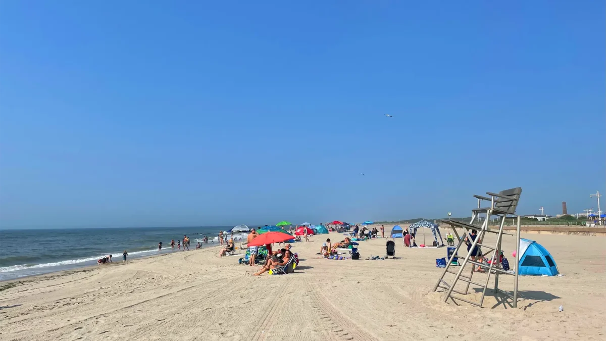 Riis Beach with people and umbrellas on sand