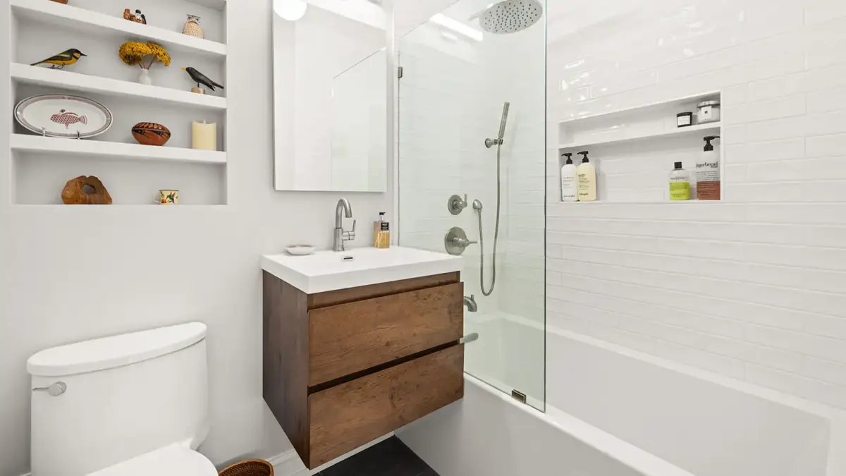 Bathroom with toilet, shelves, faucet and shower