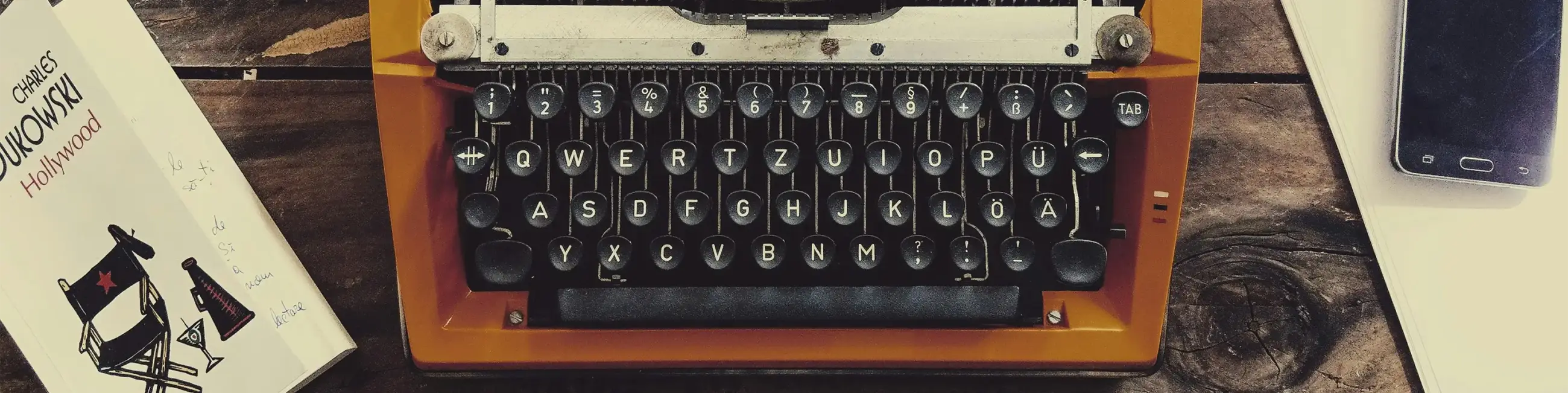 Charles Bukowski book next to typewriter