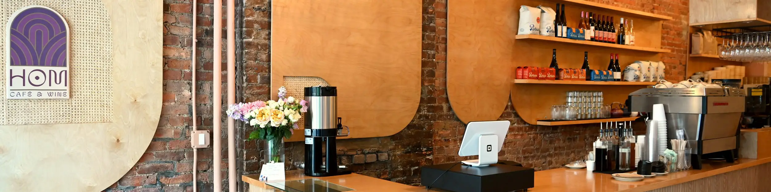 HOM Cafe interior counter with coffee supplies and flower vase