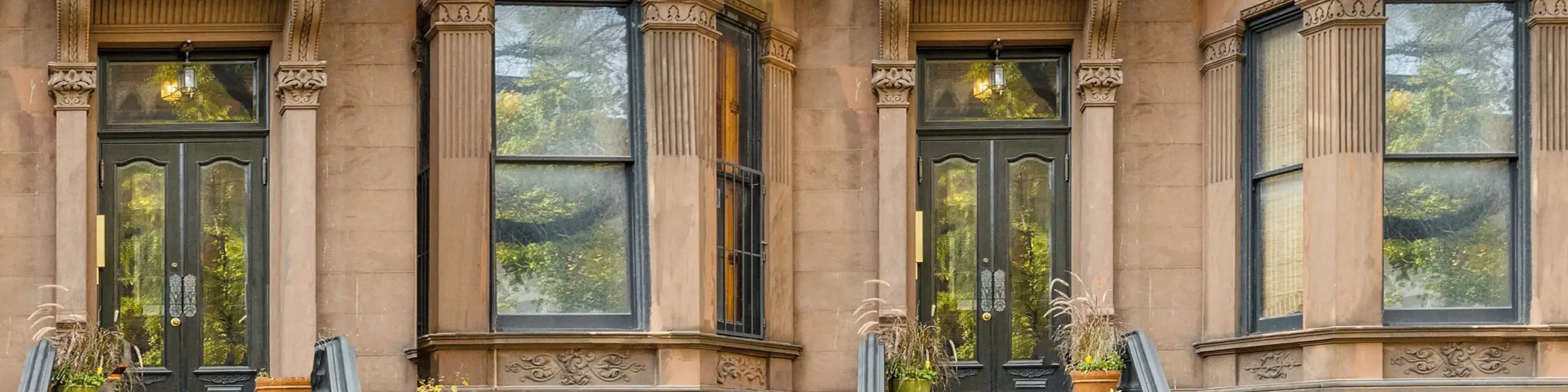 Brownstone facade with two doors and two windows