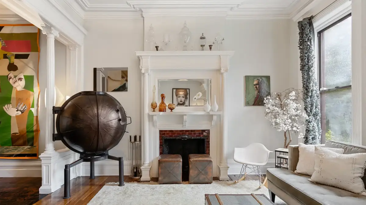 Living room interior with staged mantel, globe and side chair