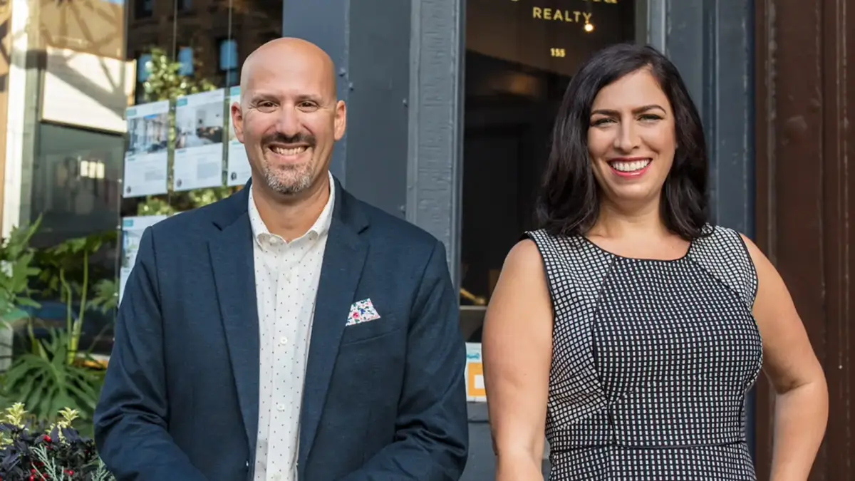 Garfield Realty Owners Paul Paglia and Elizabeth Kohen in front of Garfield office
