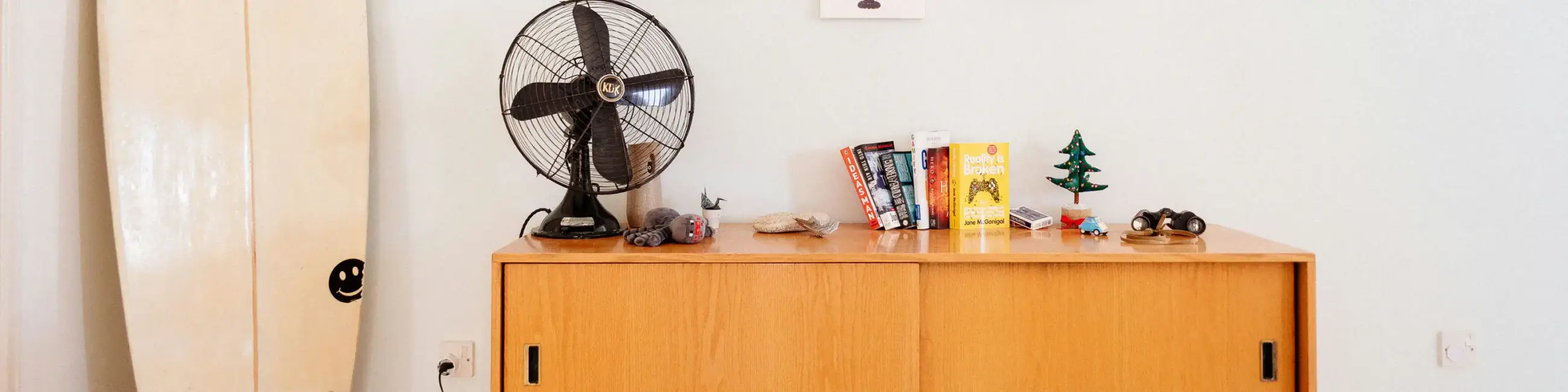 Credenza with fan, books and knicknacks