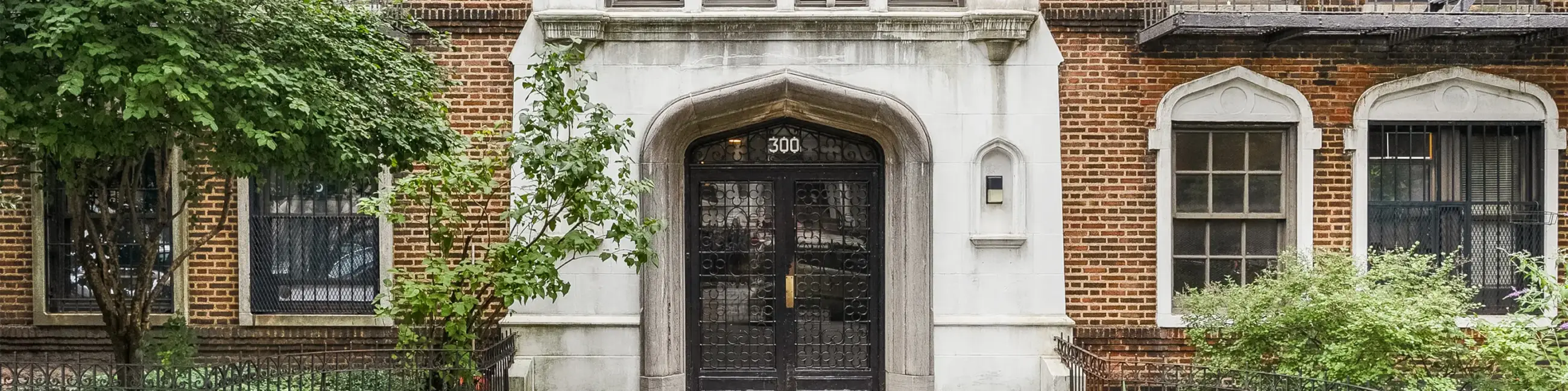 Exterior historic brick Park Slope building with shrubs